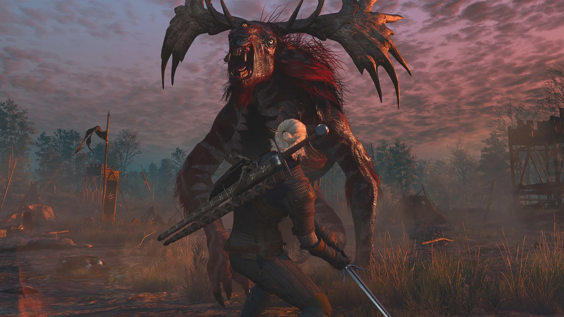Geralt, sword drawn, squaring up to a towering antlered fiend on a battle-scarred field under a red dusk sky