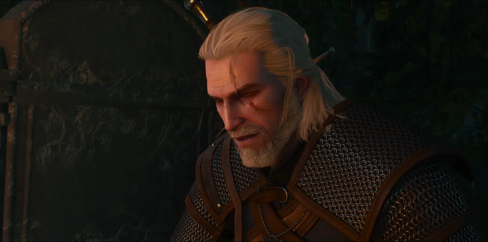 A close-up of Geralt, scarred and white-haired, in low warm light